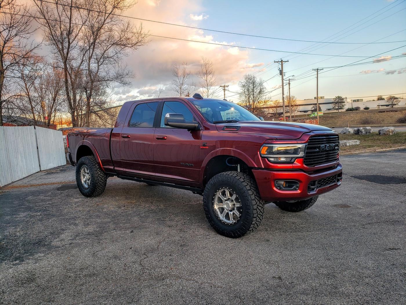 A lifted red Ram pickup at sunset