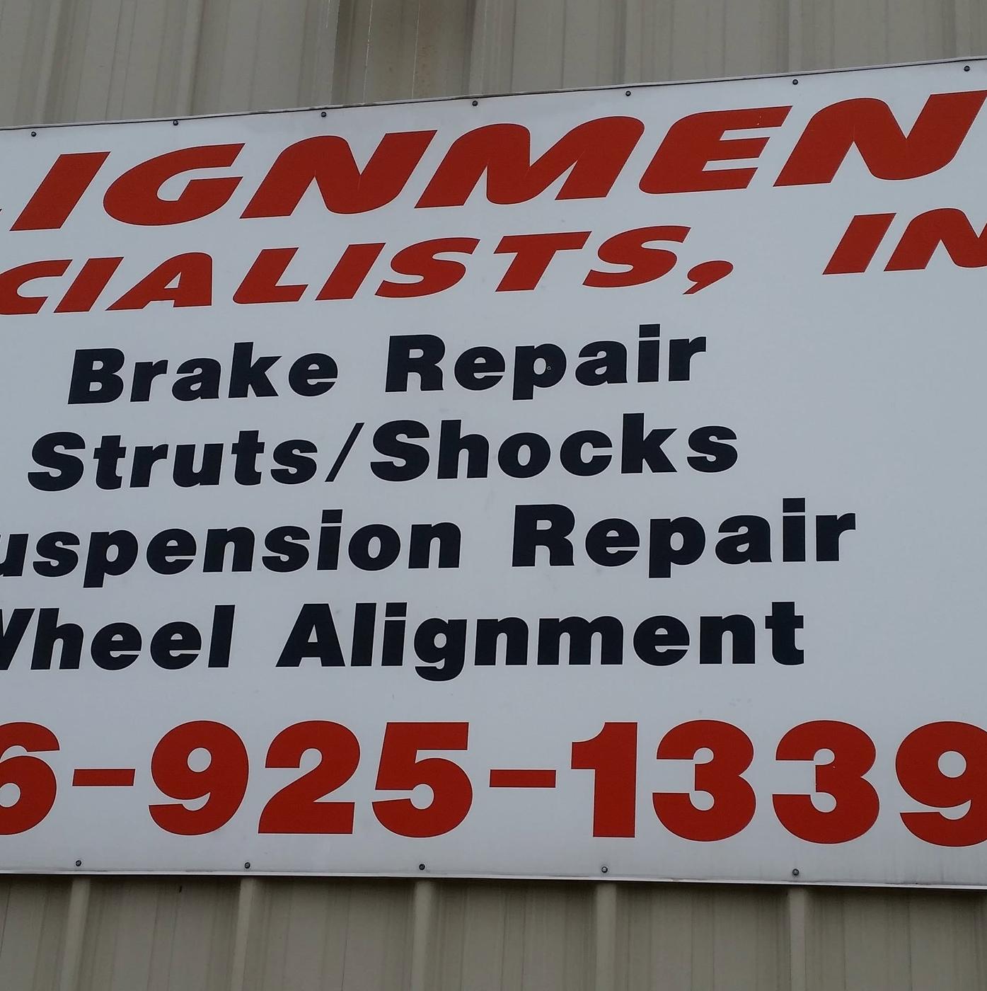 The shop's red and white sign board: Alignment Specialists, Inc. Brake Repair, Struts/Shocks, Suspension Repair, Wheel Alignment, 636-925-1339